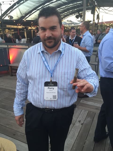 A guest holding up one of Joe's cigars at an event