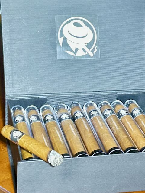 A box of Joe's cigars, each in its own tube, bearing the Cigartainment seal