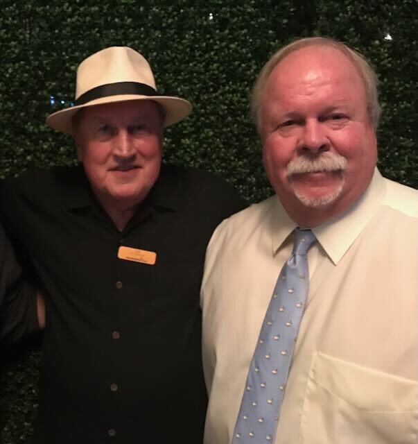 Joe with a golfer at a tournament
