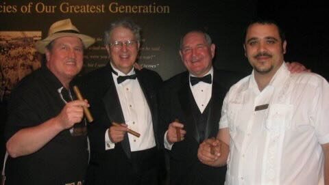 Jorge, a guest, and Joe with cigars