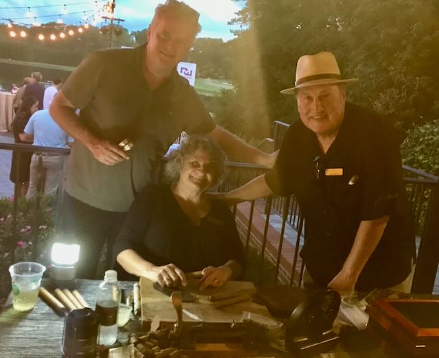 Joe, Elaine, and a guest at an outdoor evening reception