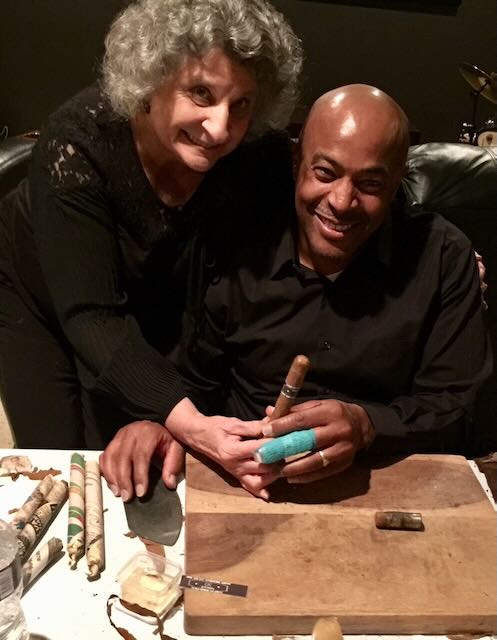 Elaine and a guest hand-rolling a cigar