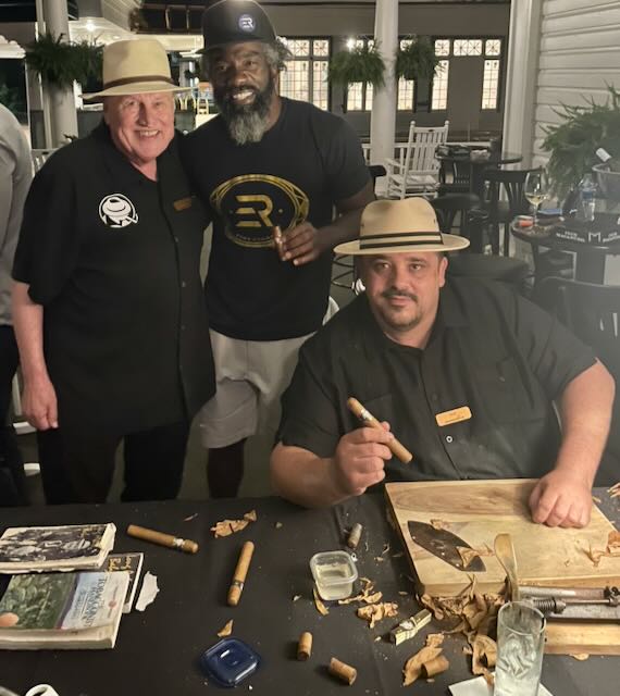 Joe and guests with cigars on a porch