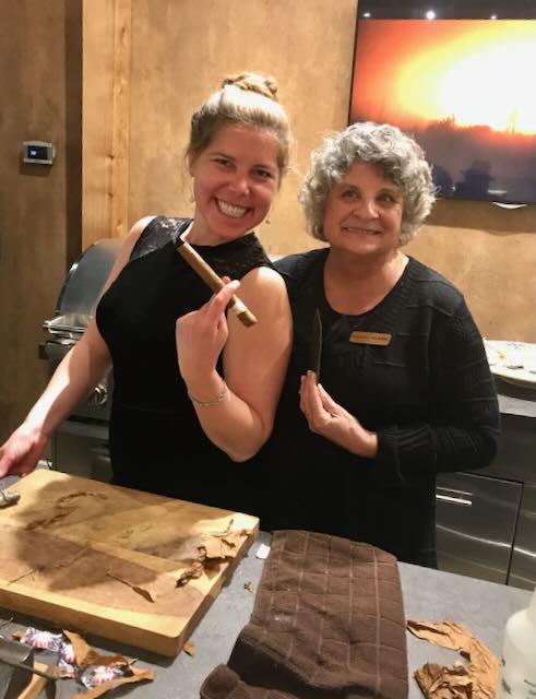 Elaine and a guest at the cigar table