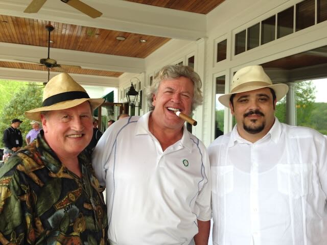 Joe with guests enjoying cigars on a clubhouse porch