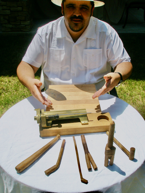 Jorge hand-rolling cigars at a table