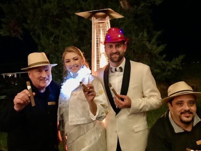 Joe and Jorge rolling cigars for a bride and groom at their reception